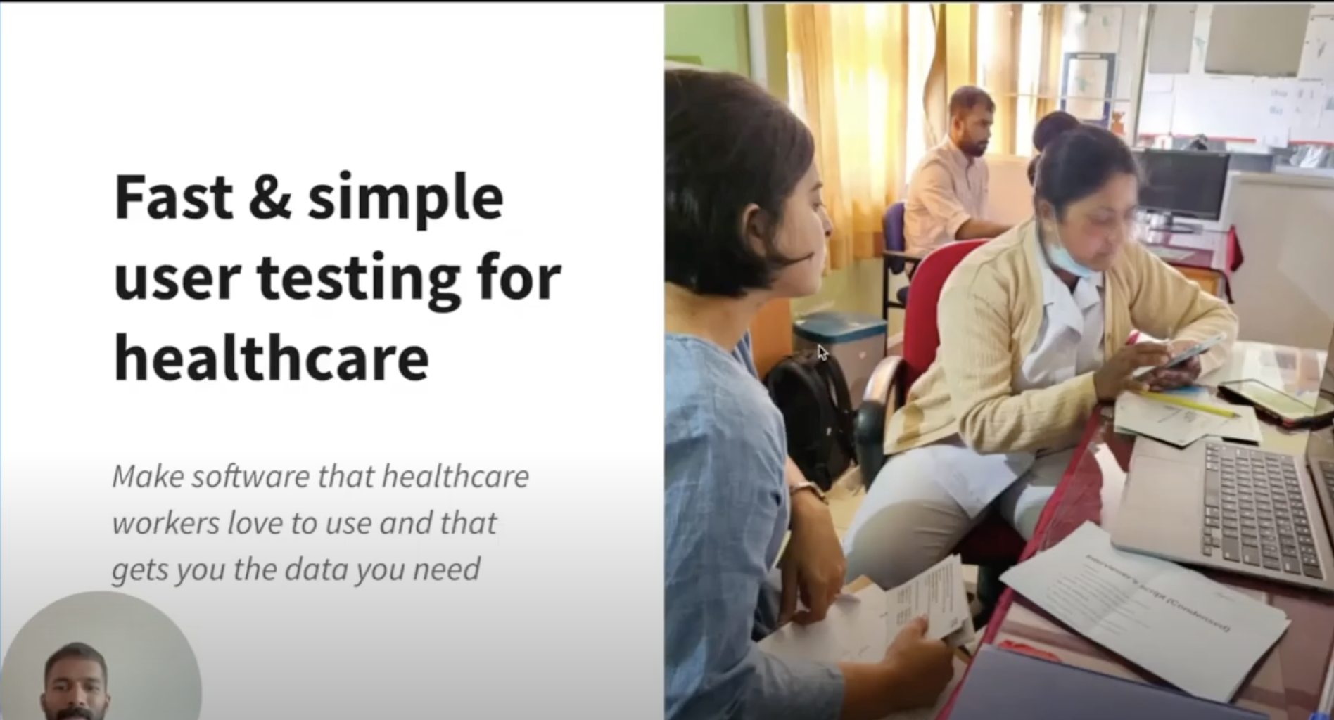 two women sit at table using digital app in healthcare setting